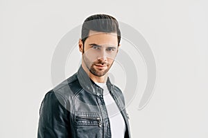 Closeup portrait of handsome trendy man posing on white studio background