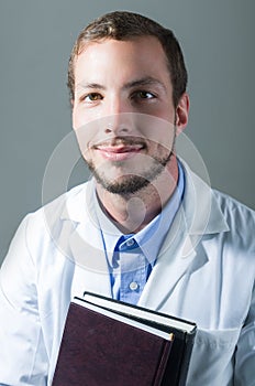 Closeup portrait of handsome young doctor holding