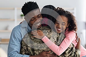 Closeup portrait of happy african american family greeting mother soldier