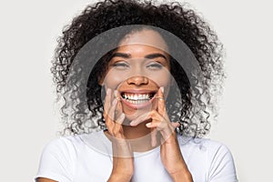 Closeup portrait happy african woman cleaning teeth with dental floss