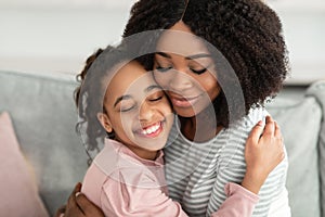 Closeup portrait of happy black mother and daughter hugging