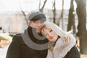 Closeup portrait of happy blonde mature woman and beautiful middle-aged brunette, looking looking directly at camera. Loving