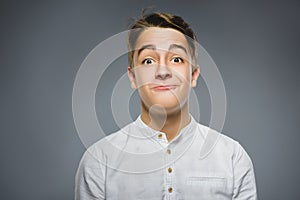 Closeup Portrait of happy boy going surprise isolated on gray background