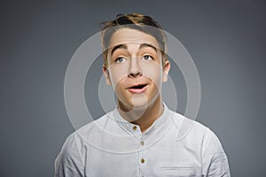 Closeup Portrait of happy boy going surprise isolated on gray background