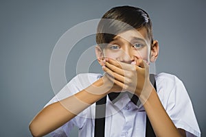 Closeup Portrait of happy boy going surprise isolated on gray background