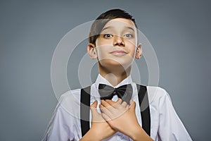 Closeup Portrait of happy boy going surprise isolated on gray background