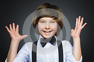 Closeup Portrait of happy boy going surprise isolated on gray background