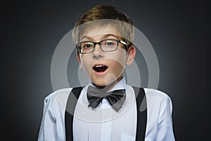 Closeup Portrait of happy boy going surprise isolated on gray background