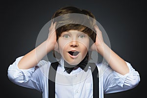 Closeup Portrait of happy boy going surprise isolated on gray background