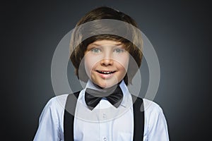 Closeup Portrait of happy boy going surprise isolated on gray background