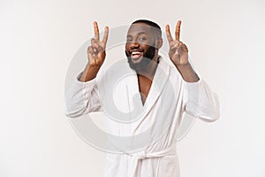 Closeup portrait happy, excited, successful young man giving peace, victory or two sign, isolated white background