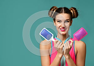 Closeup portrait of happy fashion brunette woman with colorful pink and white big square hair comb brushes