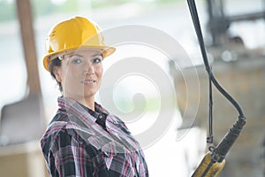 Closeup portrait happy female construction worker at site