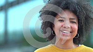 Closeup portrait of a happy female journalism student standing on campus outside. Face of a smiling and beautiful woman