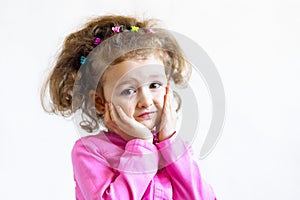 Laughing people. positive human emotions. embarrassed attractive cheerful little girl with curls, holding her cheeks