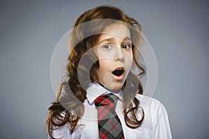 Closeup Portrait of happy girl going surprise on gray background