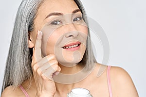 Closeup portrait of happy middle aged mature asian woman. Skin care ads.