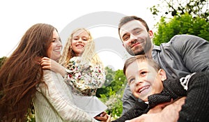 Closeup portrait of happy smiling family in city park