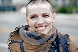 Closeup portrait of happy smiling laughing beautiful Caucasian white young bald girl woman with shaved hair head