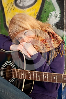 Closeup portrait of a happy young girl with guitar