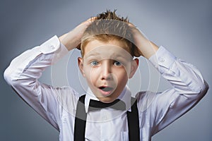 Closeup portrait headshot nervous anxious stressed afraid boy isolated grey background. Negative emotion facial