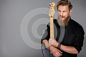 Closeup portrait of hipster man with guitar