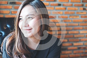 Closeup portrait image of beautiful Asian woman with smiley face and feeling good