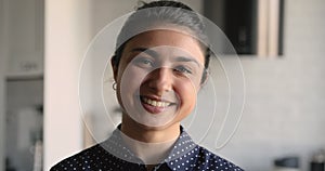 Closeup portrait of indian ethnicity female smiling looking at camera