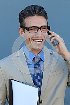 Closeup portrait of laughing young business man with glasses and wide open mouth talking on mobile phone outdoors