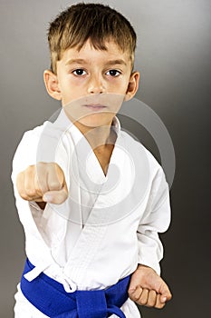 Closeup portrait of little boy training karate