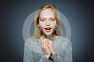 Closeup Portrait of little girl going surprise on gray background