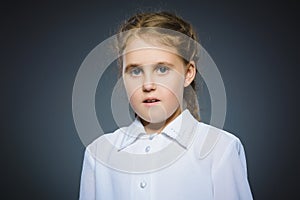 Closeup Portrait of little girl going surprise on gray background