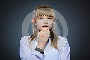 Closeup Portrait of little girl going surprise on gray background