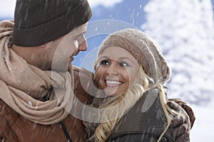 Closeup portrait of loving couple in snowfall