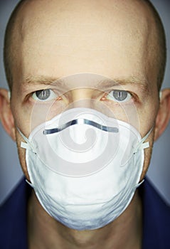 Closeup portrait of man wearing protective mask against virus and pollution