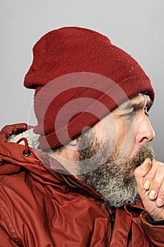 Closeup portrait of man in winter coat coughinh