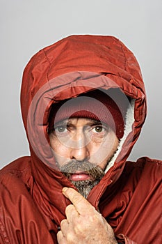 Closeup portrait of man in winter coat freezing in the cold