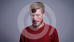 Closeup portrait of middle-aged caucasian man getting startled and confused with the background isolated on gray