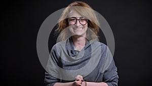 Closeup portrait of middle-aged pretty redhead female in glasses being excited and celebrating an accomplishment while