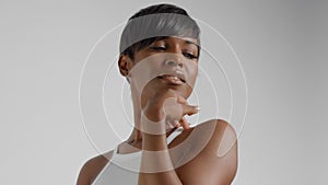 Closeup portrait of mixed race black woman with short haircut watching aside