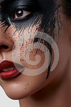 Closeup Portrait of Model with black Paint on her Face