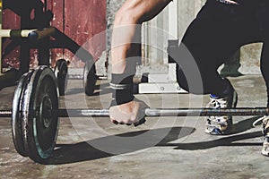 Closeup portrait of a muscular man workout with barbell