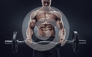 Closeup portrait of a muscular man workout with barbell at gym