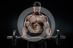 Closeup portrait of a muscular man workout with barbell at gym photo