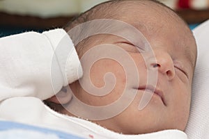 Closeup portrait of a newborn baby peacefully slept in bed