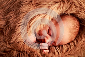 closeup portrait of newborn baby sleeping face with hand under cheek