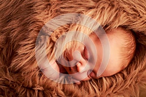 closeup portrait of newborn baby sleeping face with hand under cheek