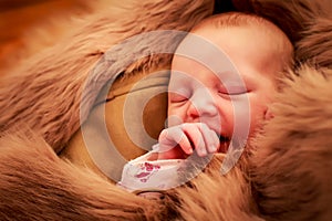 closeup portrait of newborn baby sleeping face and sucking finger