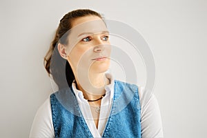 Closeup portrait of pensive woman looking to the side