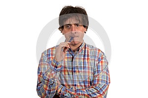 Closeup portrait of pensive young man in checkered shirt with pen